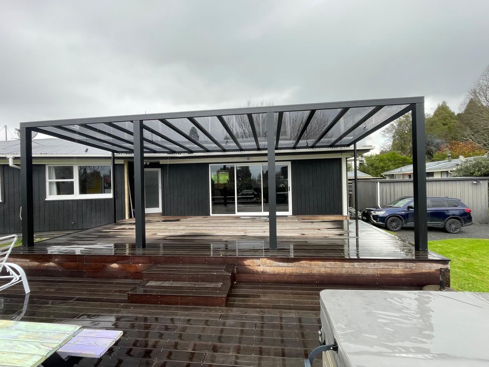 Black Ally-Golla aluminium pergola over a new timber deck