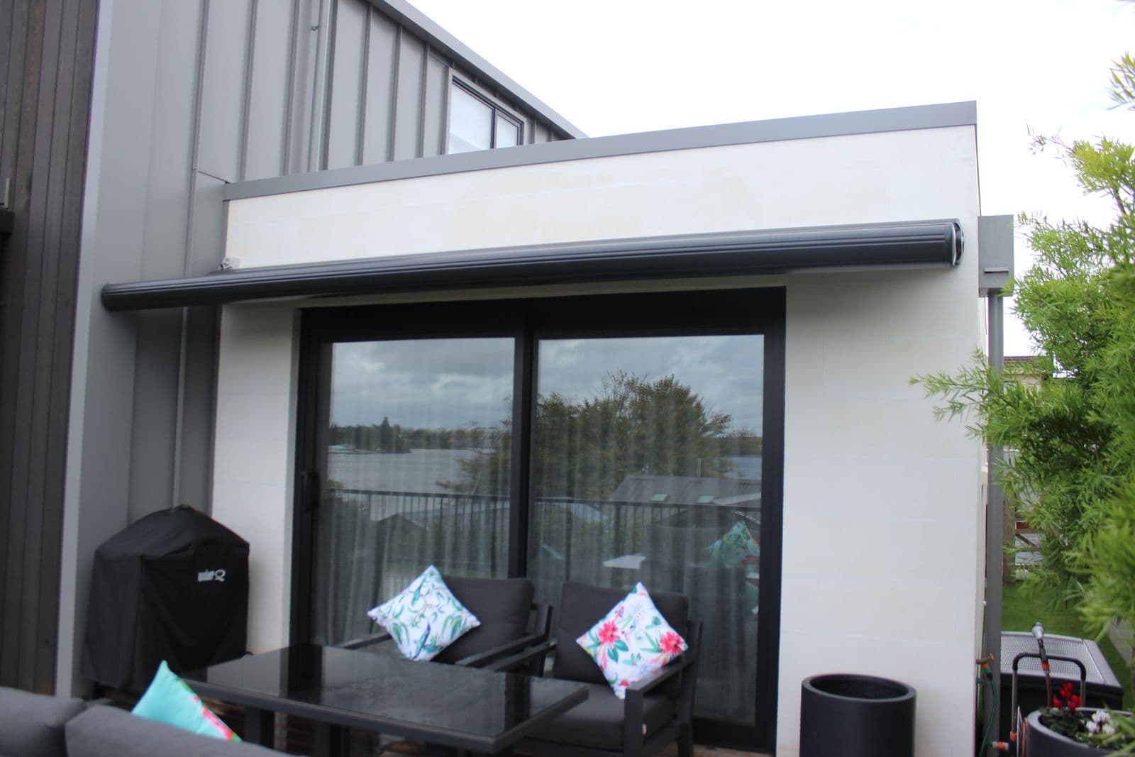 Black cassette folding arm awning on a modern home