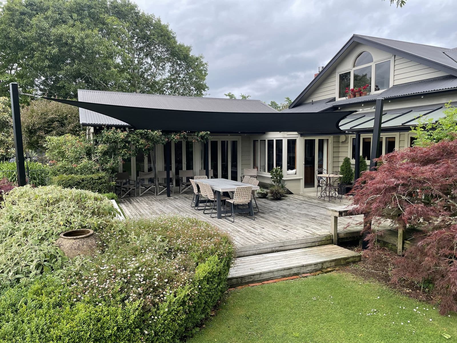 Dark shade sails over a two-storey Waikato home