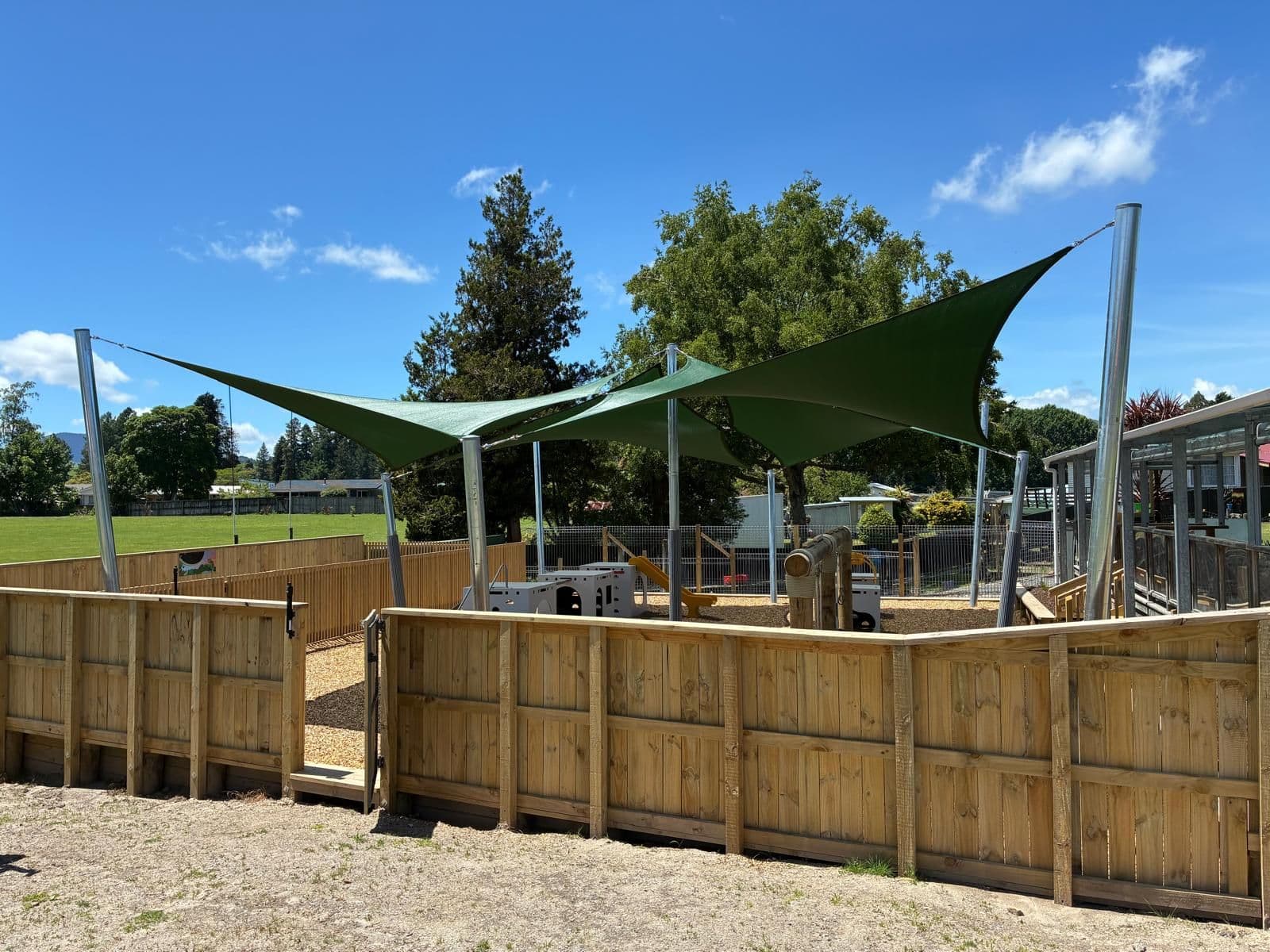 Green shade sails shading a school courtyard