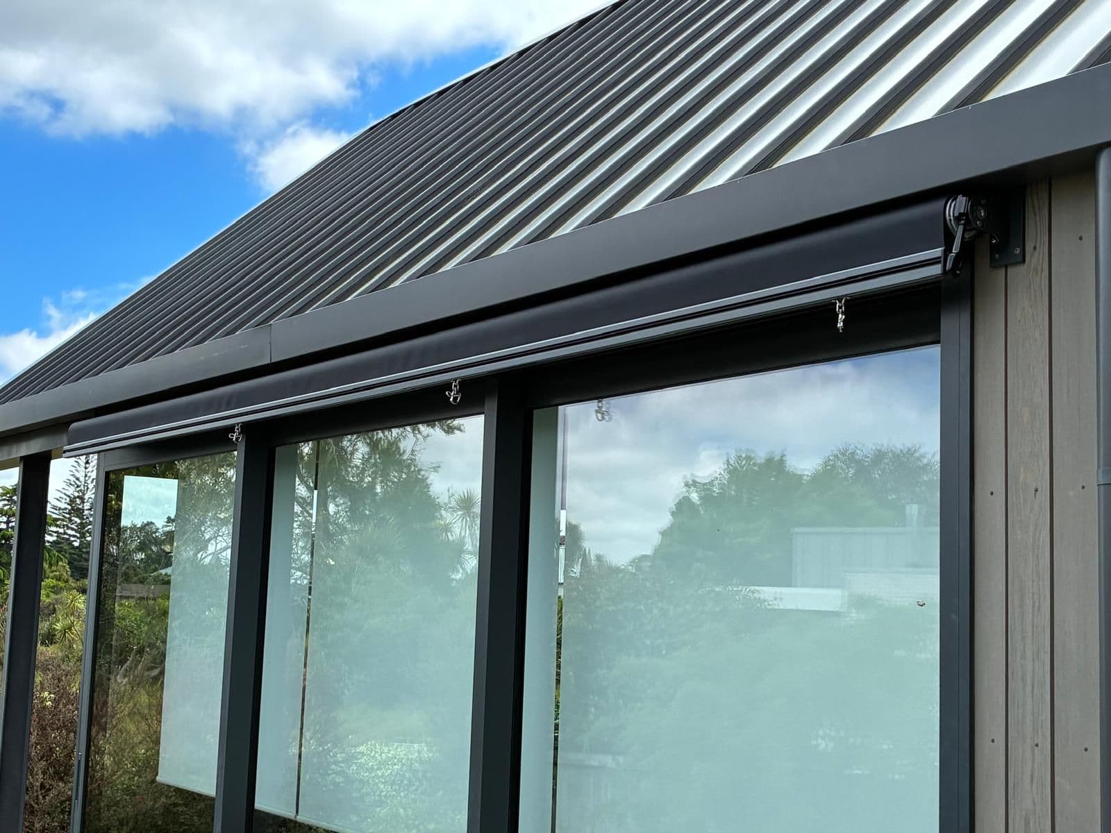 Mesh Omni outdoor blind screening a home's windows from sun