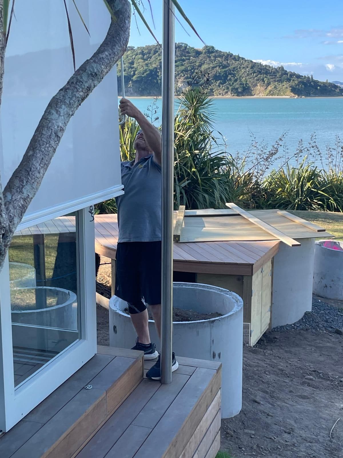 White Omni outdoor screen blinds on a seaside deck