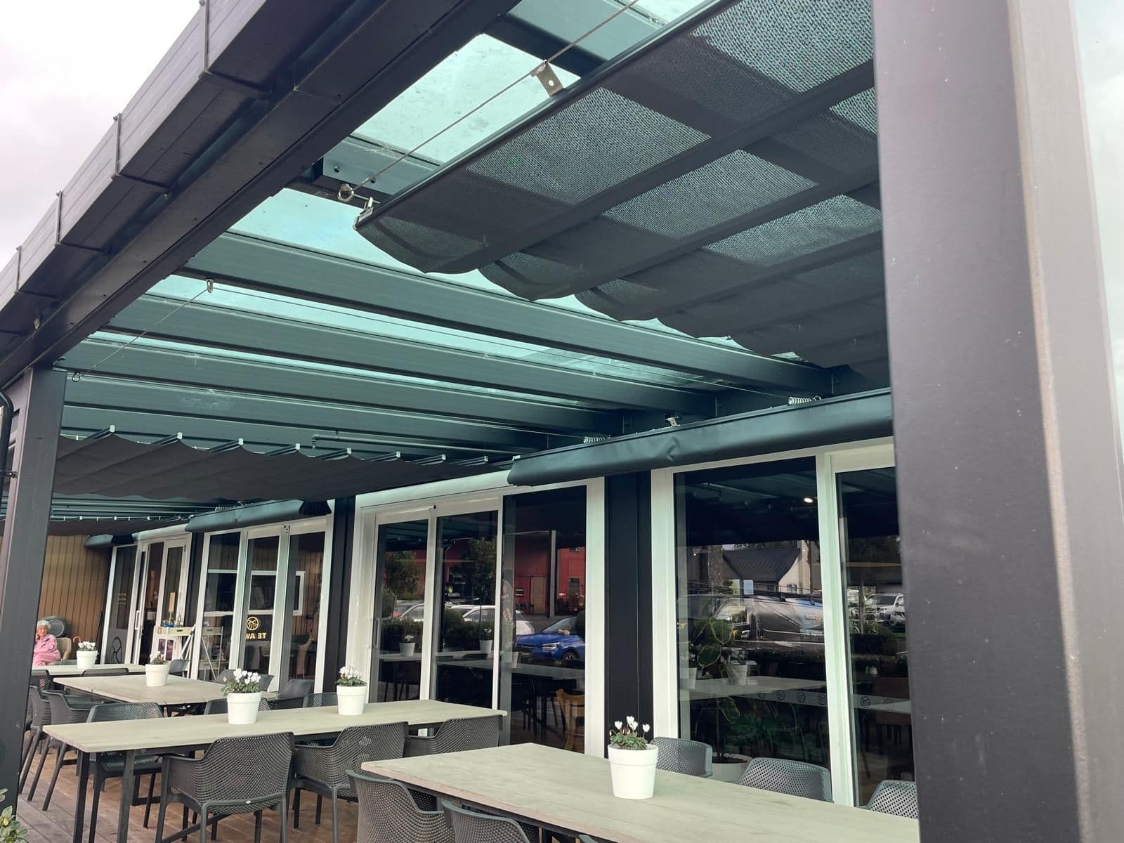 Wave shade fabric canopies shading a restaurant dining area