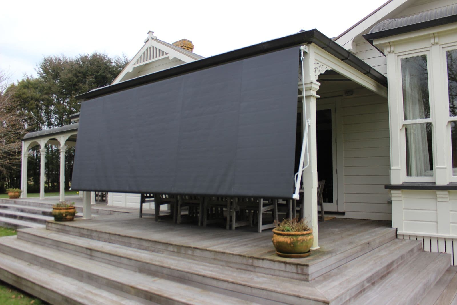 Window awning lowered for full shade on a villa veranda