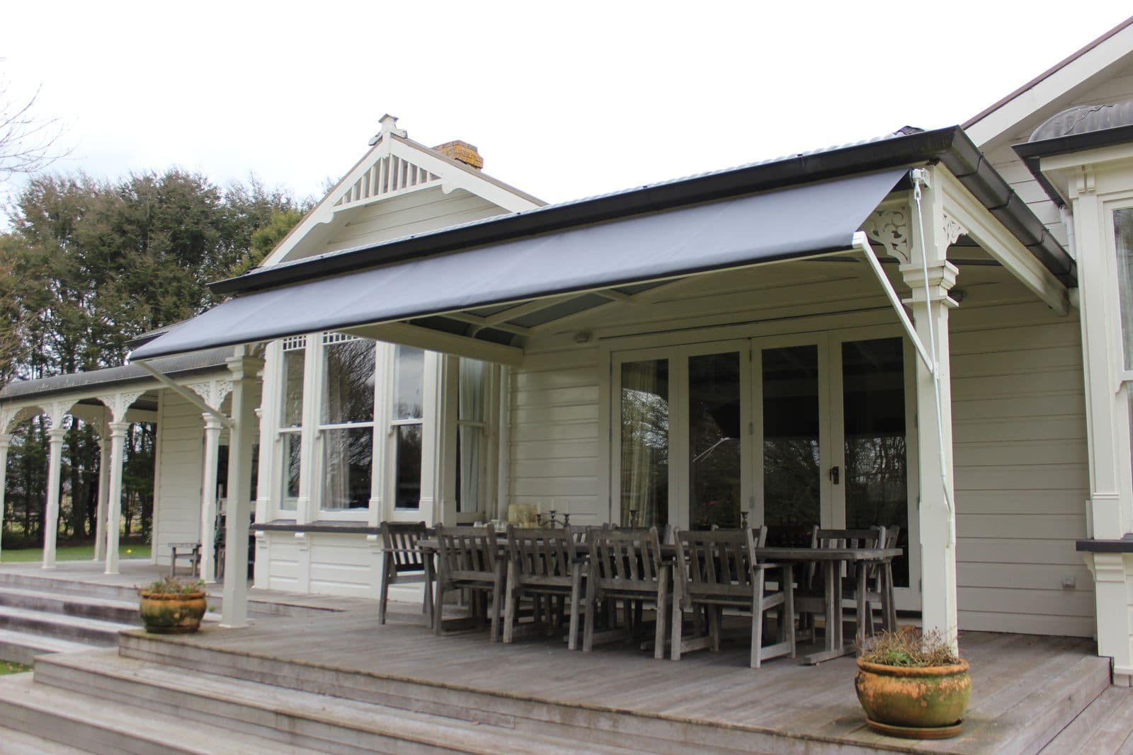 Drop-arm awning extended over a villa veranda