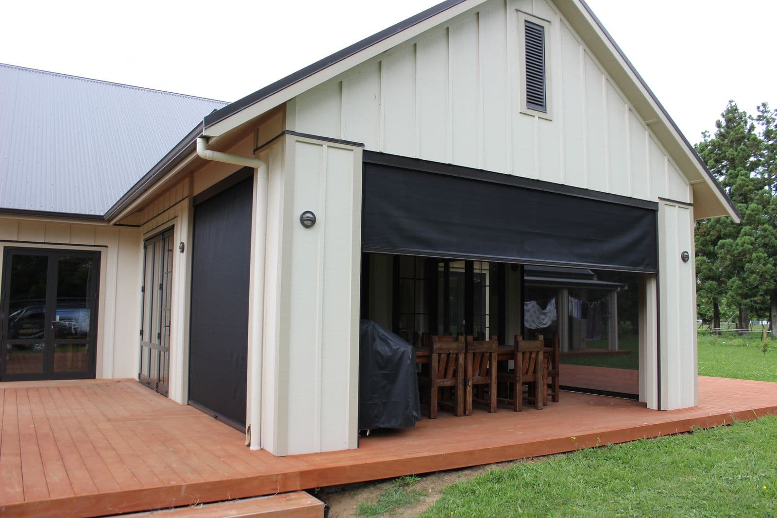 Ziptrak blinds on a barn-style home’s deck