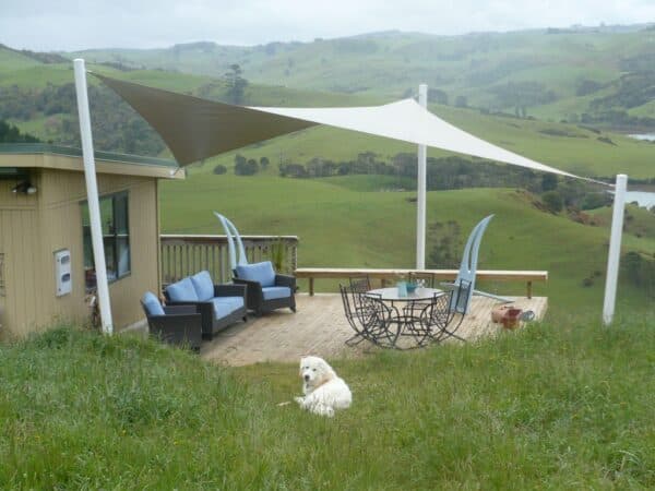 Waterproof shade sail keeping a deck dry and usable in all weather