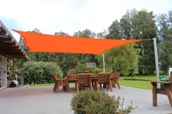 Shade sail installed over a poolside entertaining area at a modern Waikato home