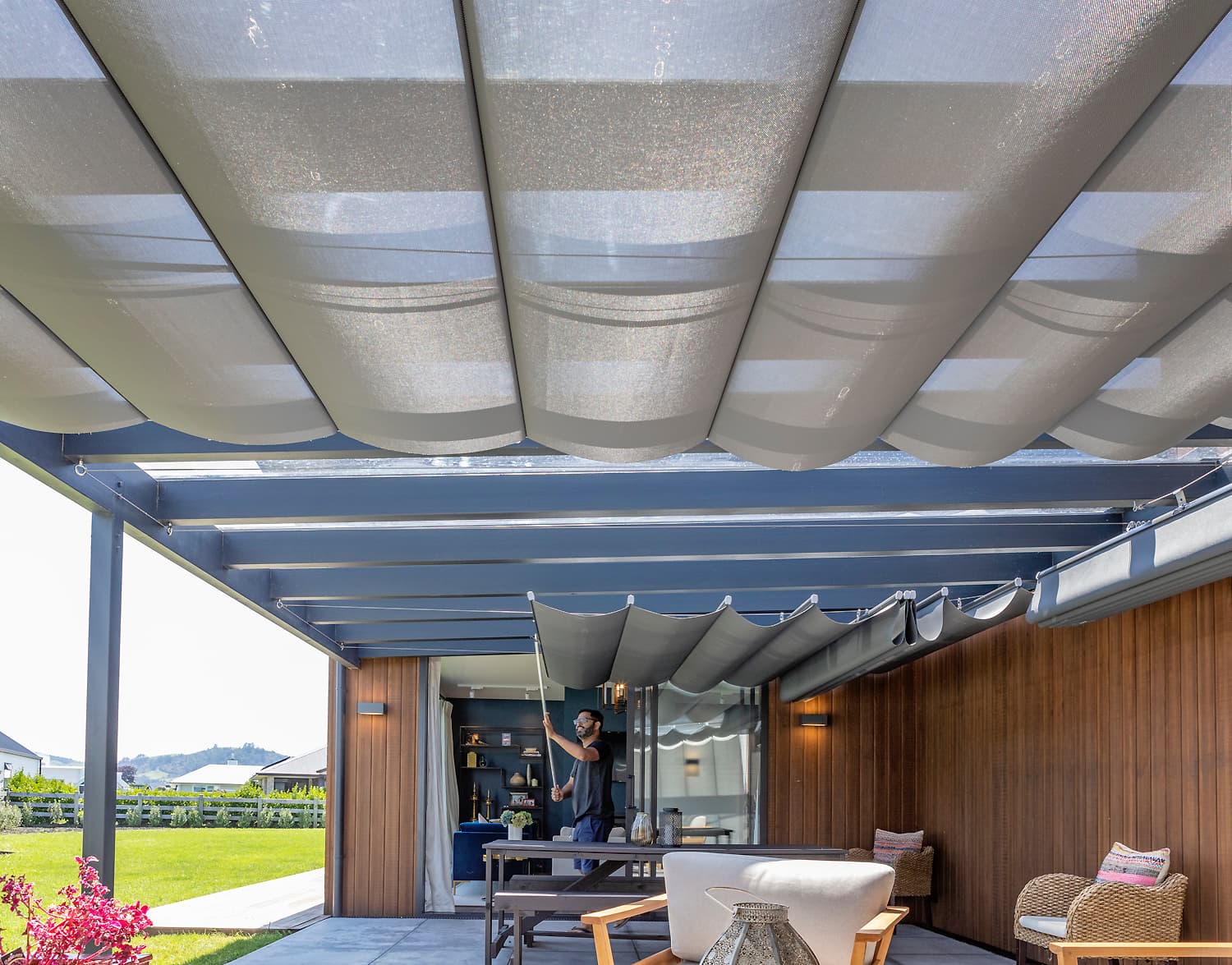 Wave shade installed over an outdoor entertaining area in Cambridge