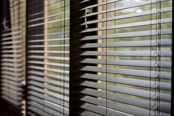 Modern wooden venetian blinds filtering light in a meeting room