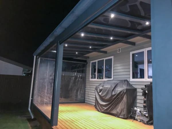 Ally-Golla canopy with clear roofing over a rear deck