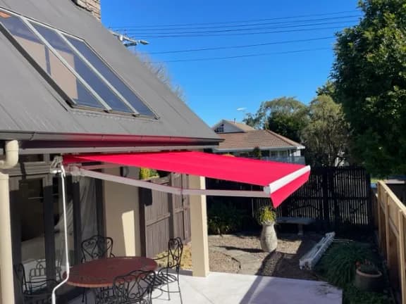 Horizon folding arm awning extended over a Waikato outdoor living area