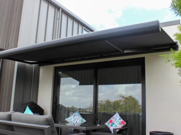 Custom awning shading a deck and outdoor furniture