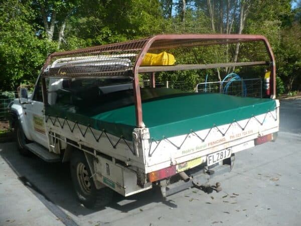 Fitted canvas cover protecting outdoor equipment