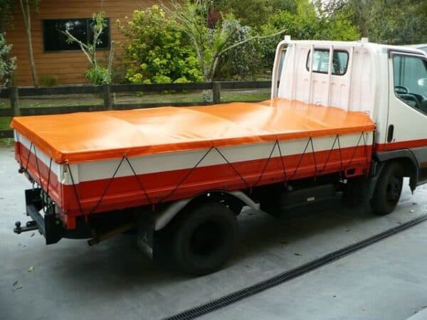 Heavy-duty customised cover secured over a trailer