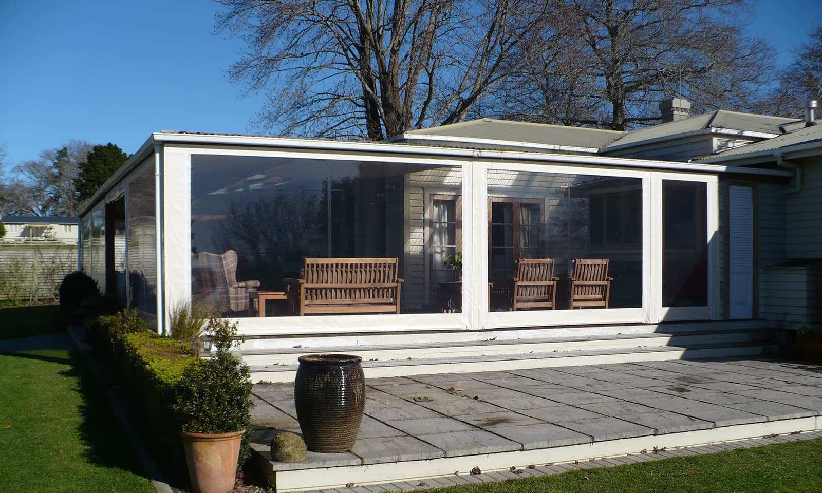 Clear outdoor cafe blinds enclosing a covered deck