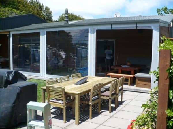 Outdoor cafe blinds enclosing a hospitality seating area