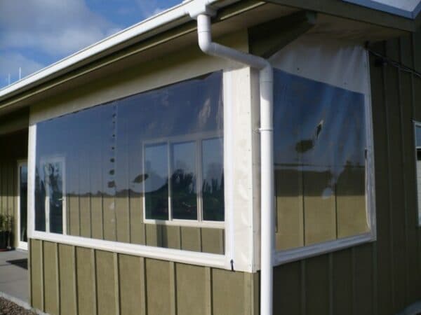 Clear PVC patio blinds sheltering an outdoor dining space