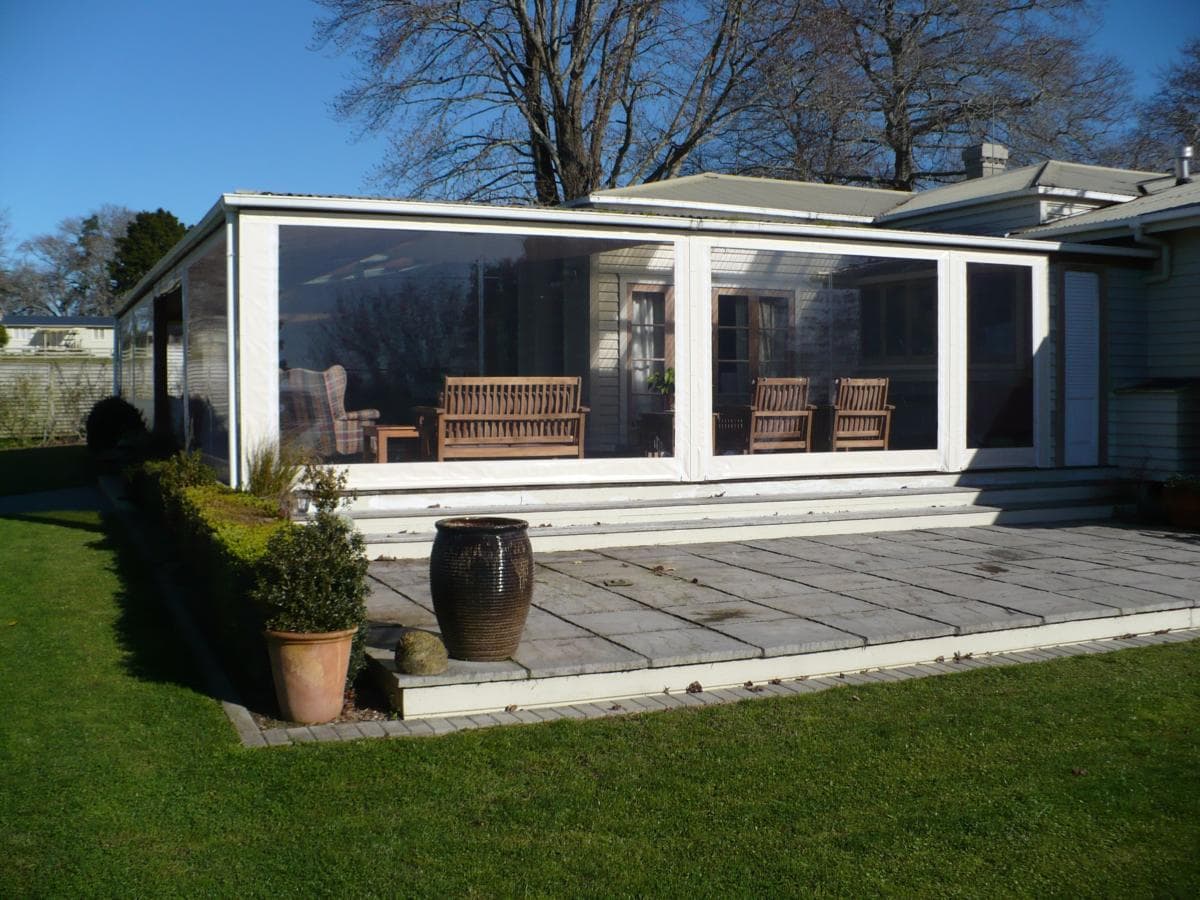 Clear PVC cafe blinds enclosing an outdoor dining area