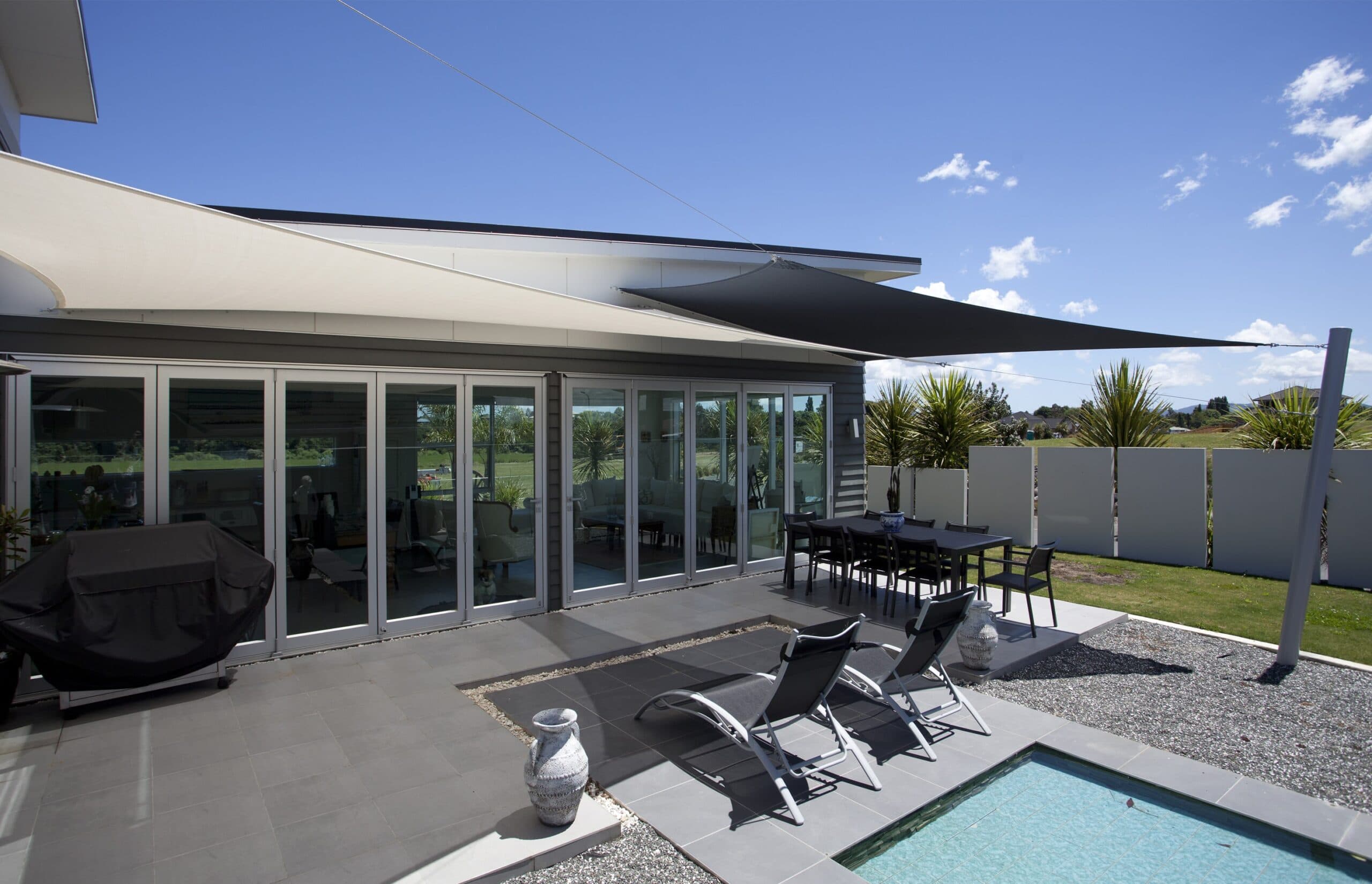Large tensioned shade sail over an outdoor area