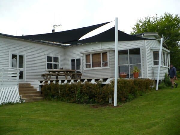 Custom shade sail shading a Waikato home's deck