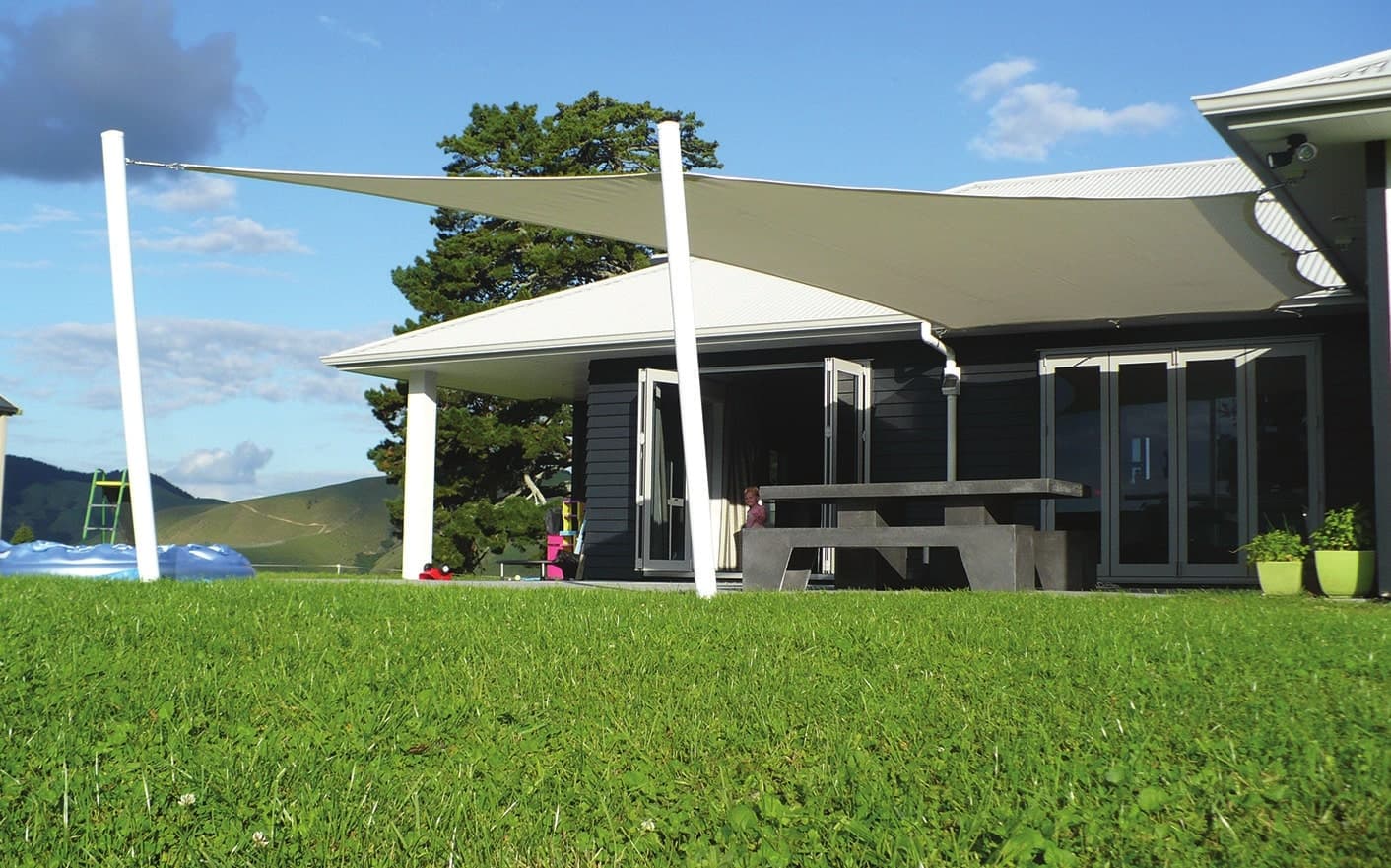 Shade sail spanning an outdoor living space