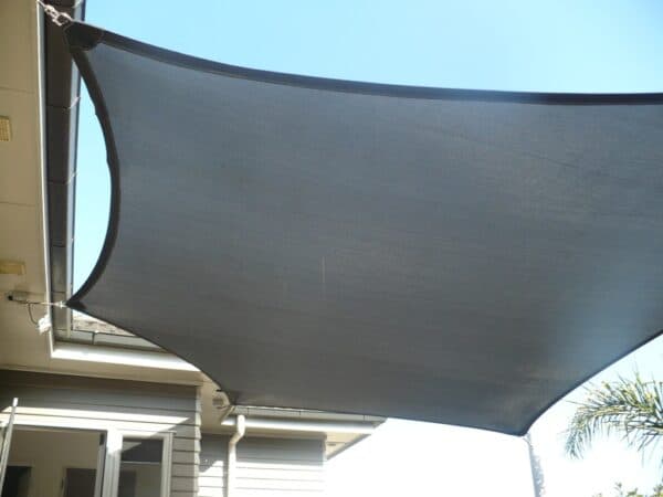 Overlapping shade sails above a playground area