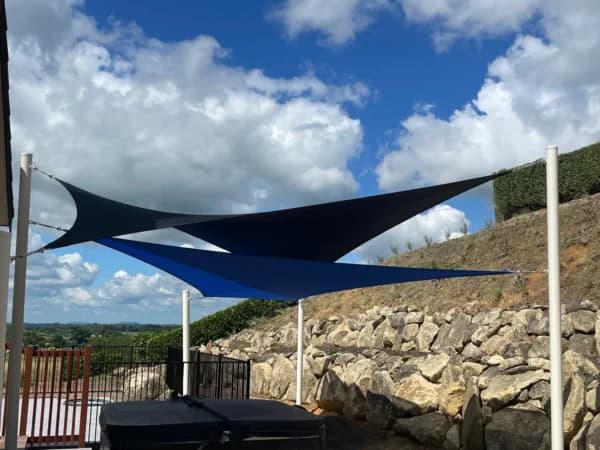 Twin shade sails over an outdoor entertaining space