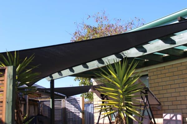 Shade sail providing sun protection for an outdoor seating area