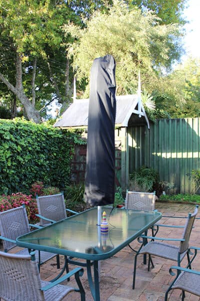 Shade7 centre-pole umbrella beside outdoor seating