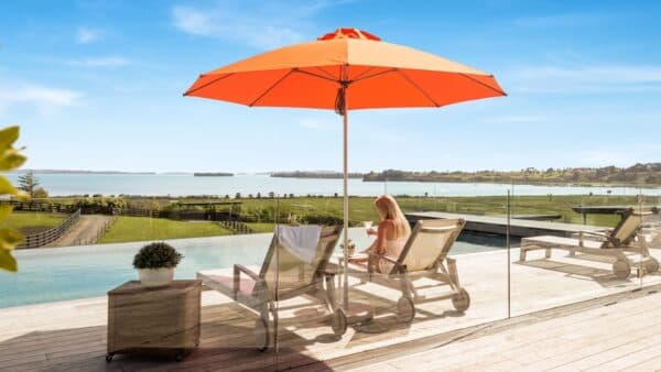 Orange Shade7 outdoor umbrella shading poolside loungers
