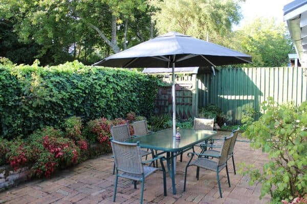 Shade7 umbrella over a poolside deck