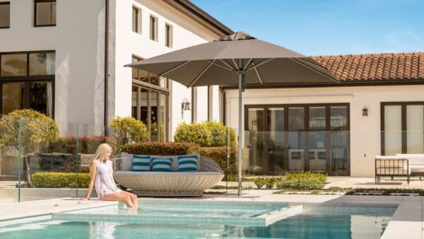 Square charcoal Shade7 Milan outdoor umbrella on a deck