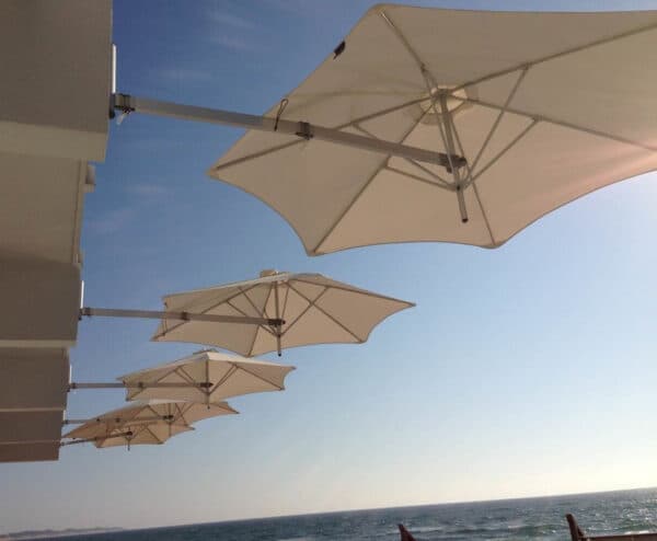 Wall-mounted Shade7 Paraflex sun umbrellas over outdoor seating