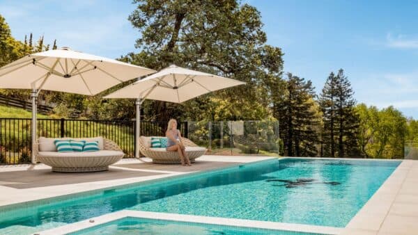 White Shade7 Riviera cantilever umbrella beside a pool