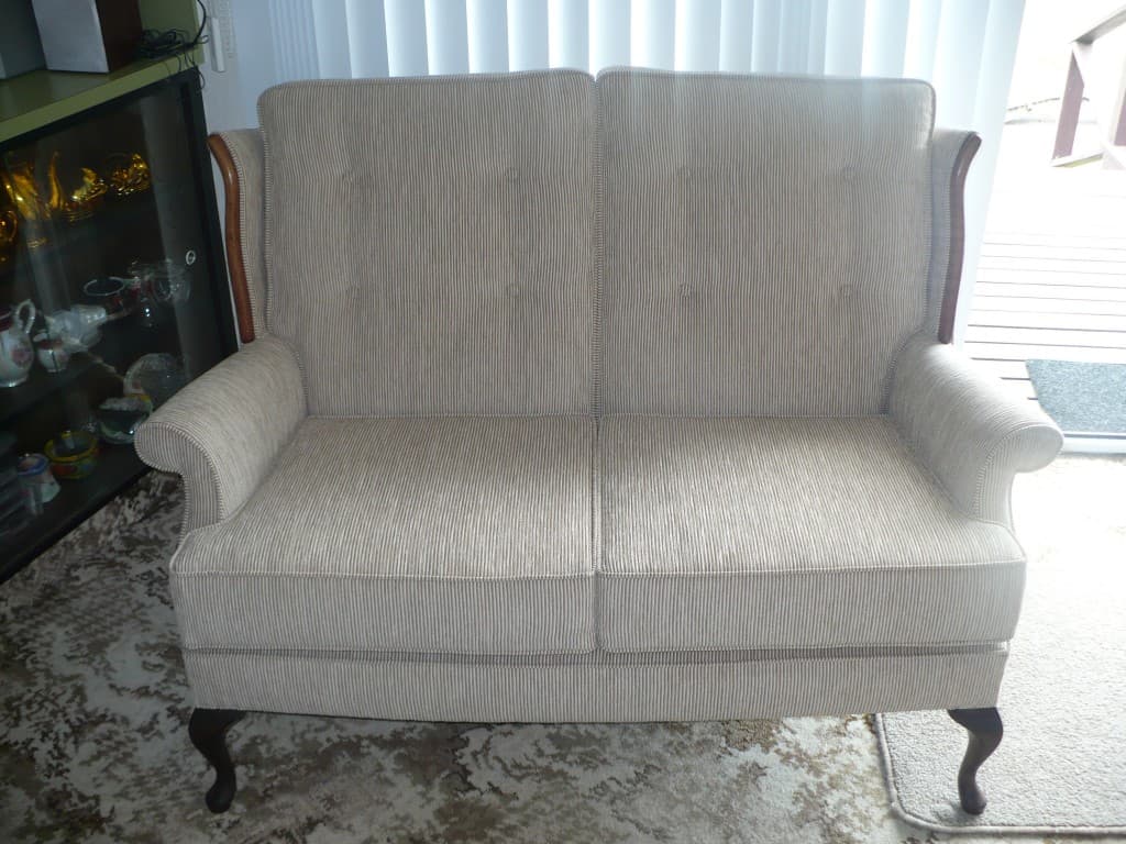 Antique two-seater couch restored with fresh cream upholstery