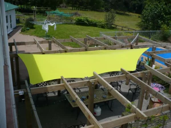 Waterproof PVC sail installed over a residential courtyard