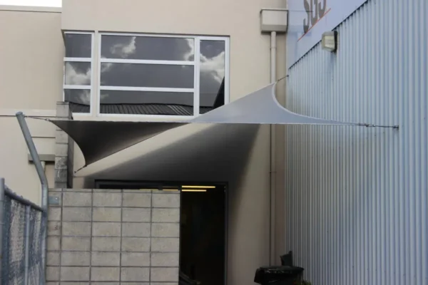 White waterproof shade sail sheltering an outdoor dining area