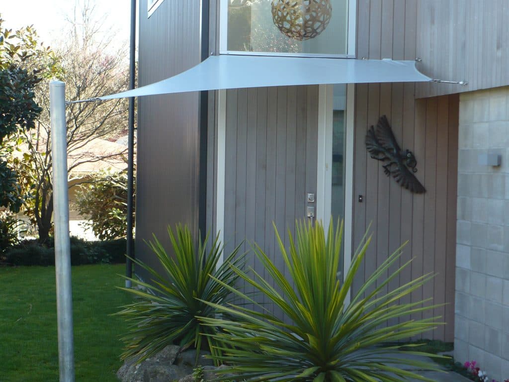 Heavy-duty waterproof shade sail with galvanised poles over an outdoor area