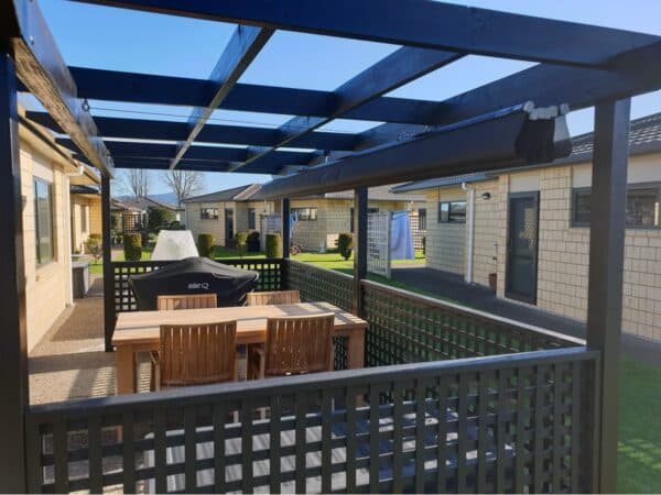 Cream wave shade canopy over an outdoor table setting