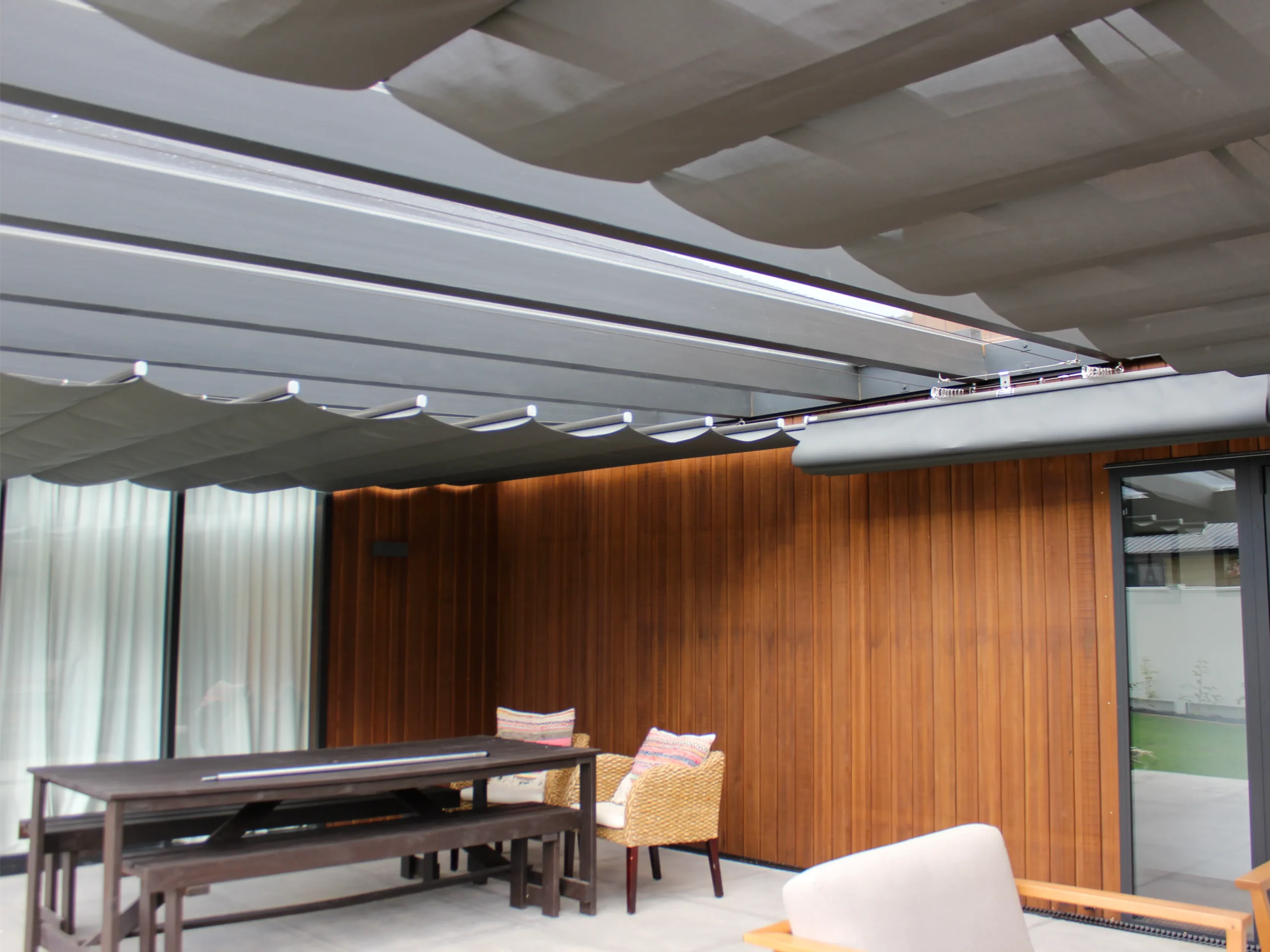 Wave shade canopy over an alfresco area