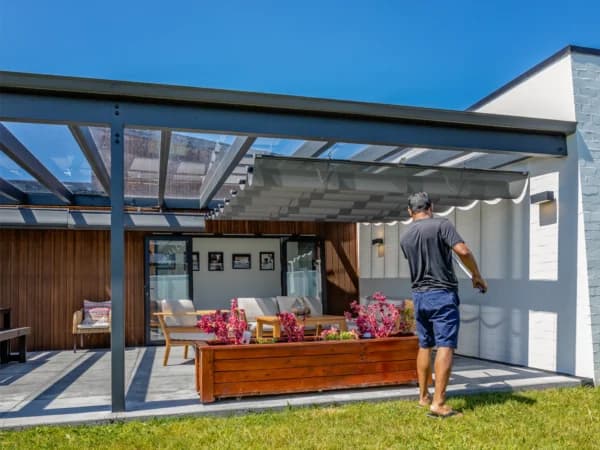 Wave shade canopy shading a Cambridge outdoor living area