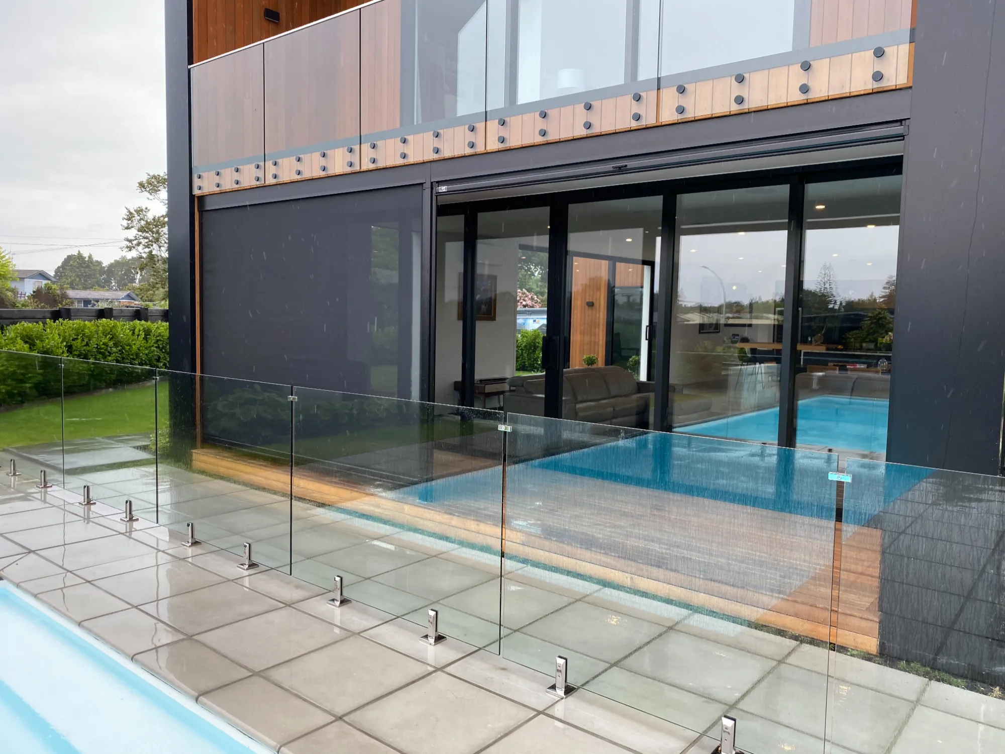 Ziptrak outdoor blinds enclosing a patio beside a pool