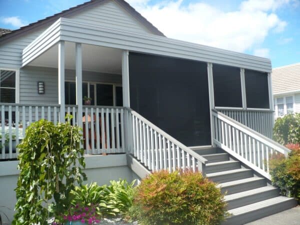Outdoor blinds sheltering a covered deck area